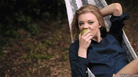 GIF donna si dondola su un'amaca e mangia una mela