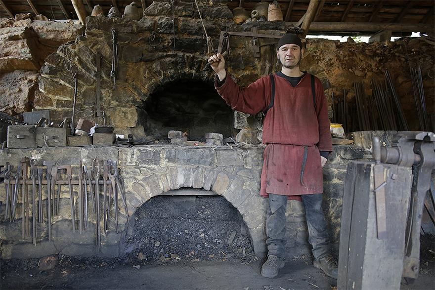 Un vero fabbro medievale nel castello di Guédelon.
