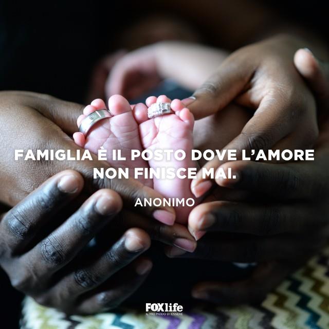 Citazione importanza della famiglia Mani di genitori che sorreggono i piedi di un neonato
