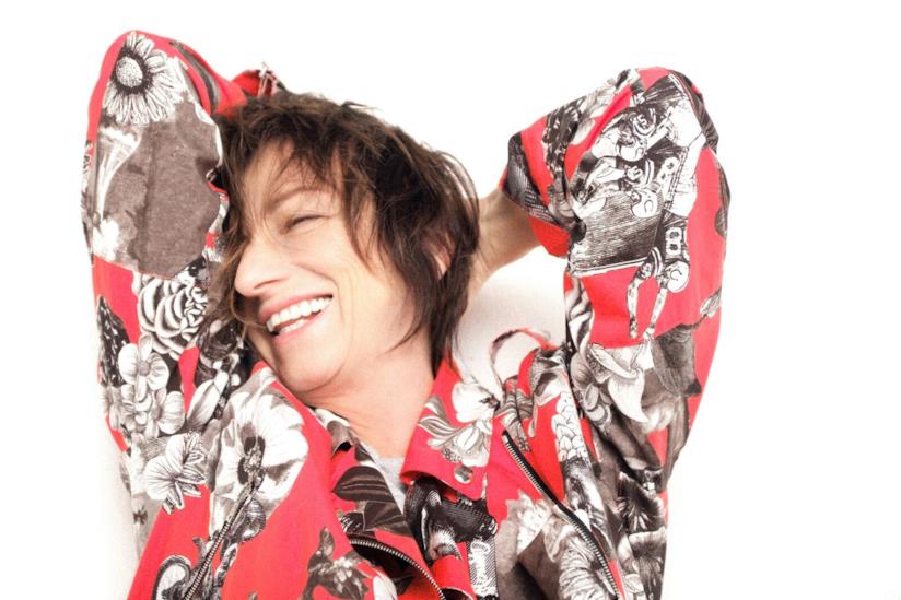 Gianna Nannini oggi compie gli anni Primo piano della Nannini, sorridente, con una maglia con fantasia floreale, braccia dentro la nuca