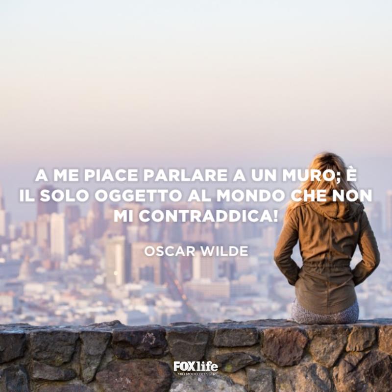 Frase divertente Ragazza seduta su un muretto di spalle