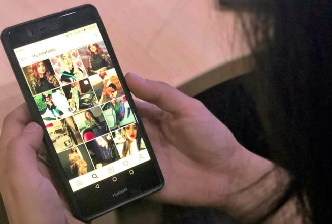 Il fine è quello di aiutare le persone a non diventare dipendenti da Instagram. Una mano che tiene uno smartphone acceso.