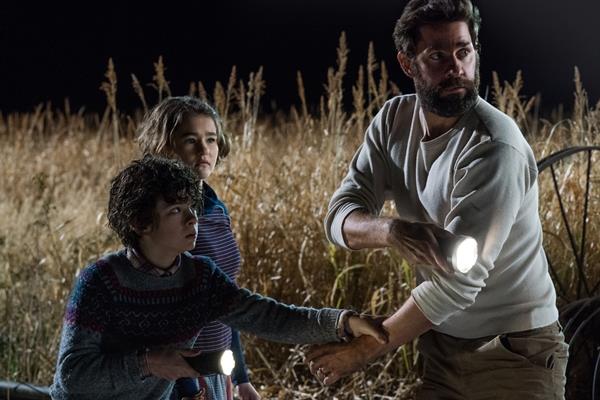 L'attore e regista di A Quiet Place, John Krasinski, con il giovane cast del film Noah Jupe, Millicent Simmonds e John Krasinski in una immagine del film A Quiet Place