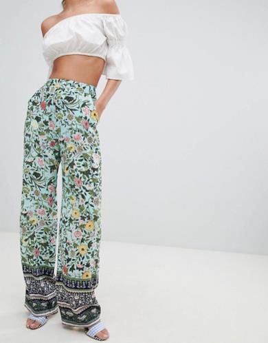 Pantaloni palazzo con stampa a fiori e bordo decorato