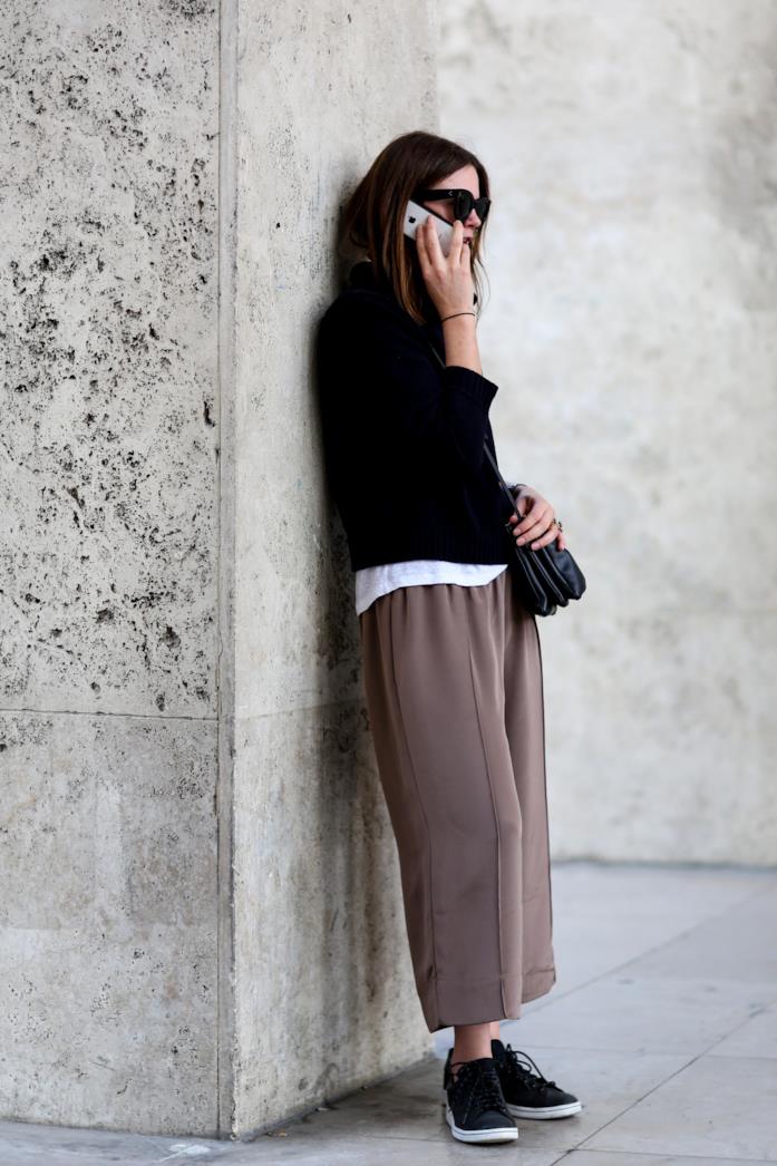 Sneakers nere abbinate ai culotte Sneakers nere indossate con pantaloni a gamba larga e pullover