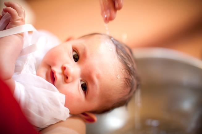 Frasi da scrivere sui biglietti d'auguri di un battesimo Neonato sottoposto al rito battesimale