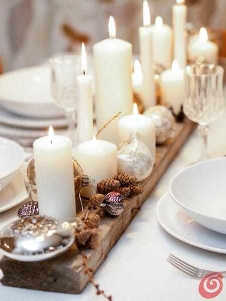 Centrotavola con candele e pigne Centrotavola natalizio