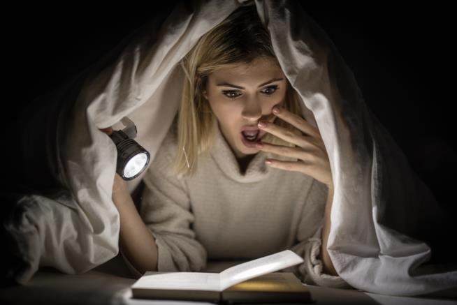 Libri da paura per un Halloween da brivido Ragazza legge un libro horror