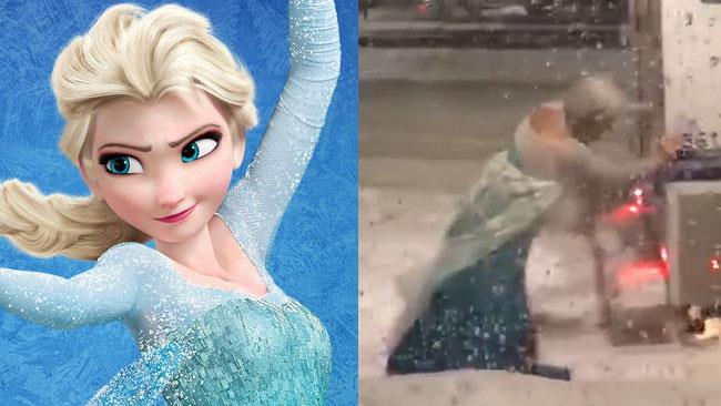 La drag queen Elsa libera il van della polizia intrappolato nella neve Una drag queen di Boston vestita da Elsa inenta a spingere il van della polizia