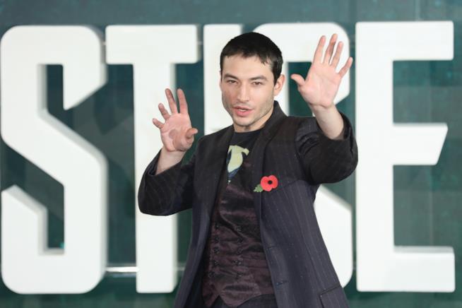 Ezra Miller è sempre il protagonista nel nuovo film su Flash Mezzobusto di Ezra Miller su sfondo con logo della Justice League