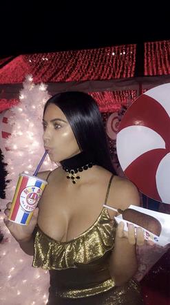Kim Kardashian Kim Kardashian con in mano un hot dog alla festa di Natale